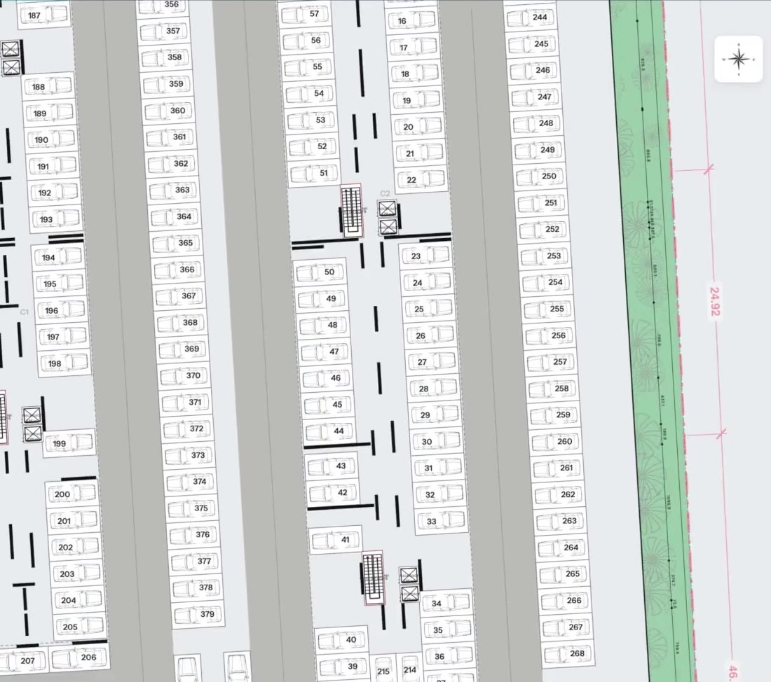A generated basement: parking stalls and aisles, the cores with their stairs and lifts, under the buildings